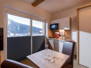 a kitchen with a table with glasses on it at Blaiken Appartements in Scheffau am Wilden Kaiser in Scheffau am Wilden Kaiser