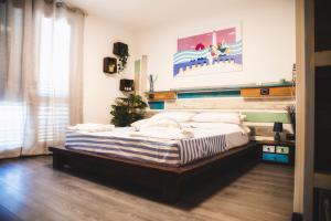 a bedroom with a large bed with a wooden headboard at Homiday - Bel Salento Specchia in Specchia