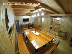 an overhead view of a large wooden table in a cabin at Cabaña las trancas in Nevados de Chillan