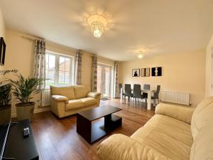a living room with a couch and a table at Homely 3 bedroomed House in Bicester in Bicester