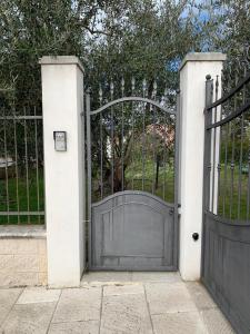 an entrance to a gate with a gray door at Nonna Nesti in Cortona