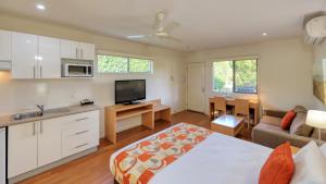 a kitchen and living room with a bed and a couch at Chinchilla Motor Inn in Chinchilla