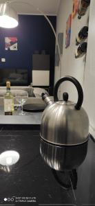 a metal tea kettle sitting on top of a stove at Urban Loft in Trieste