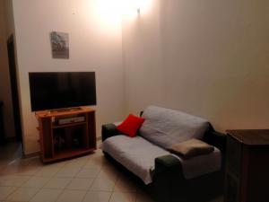 sala de estar con sofá y TV de pantalla plana en Appartamento Santa Giusta, en Santa Giusta