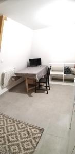a room with a table with a laptop on it at Equipée 1 pièce proche Paris in Argenteuil