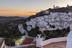 a group of white buildings on a hill at Casa de Luz in Casares