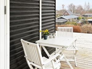 a white table and two chairs on a deck at 5 person holiday home in B rkop in Egeskov