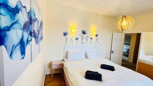 a bedroom with a bed with two pillows on it at Summer Breeze - Cosy & Warm Holiday Home in Youghal's heart - Family Friendly - Long Term Price Cuts in Youghal