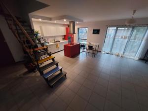 a living room with a staircase and a kitchen at Galeria kolorów pokój 4 osobowy in Łódź