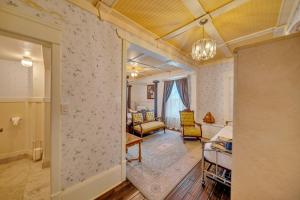 a living room with a bedroom and a living room with a room at Marmora and Lake Inn and Victorian Diner in Marmora