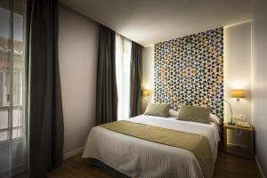 Posteľ alebo postele v izbe v ubytovaní Hotel Comfort Dauro 2