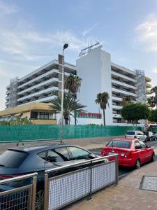 two cars parked in a parking lot in front of a building at Apartment Modern 2 Playa del Ingles in San Bartolomé de Tirajana