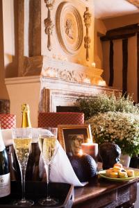 a table with two glasses of champagne and a plate of food at La Venelle Saint Jean in Honfleur