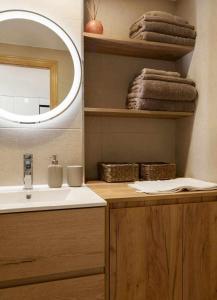 a bathroom with a sink and a mirror at Apartamento Elurra Formigal in Formigal