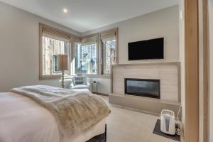 a bedroom with a bed and a tv and a fireplace at Premium One Bedroom apartment hotel in Park City