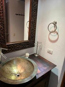 a bathroom with a sink with a large mirror at VILLA EN MORROCOY in Tucacas