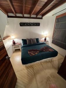 a bedroom with a bed and two night stands at VILLA EN MORROCOY in Tucacas