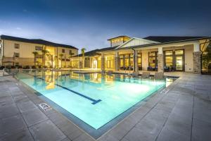a large swimming pool in front of a building at Ideal Modern Retreat in Jacksonville
