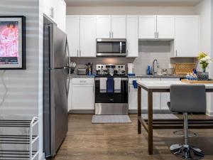 a kitchen with a refrigerator and a table in it at Ideal Modern Retreat in Jacksonville