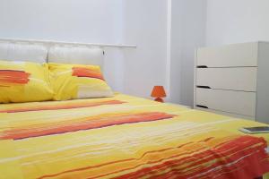 a bed with a colorful blanket and a dresser at Le colibri voyageur in Sans Pareil +38 photos