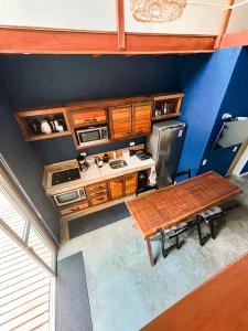 an overhead view of a kitchen with a wooden table at Surfway Ilha do Mel Lofts in Ilha do Mel