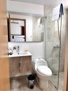 een badkamer met een toilet, een wastafel en een douche bij Brand New Apt in PUNTA CANA. in Punta Cana