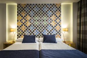 Posteľ alebo postele v izbe v ubytovaní Hotel Comfort Dauro 2