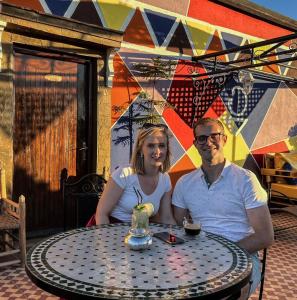 a man and a woman sitting at a table at Riad Chay & Boutique in Ouarzazate