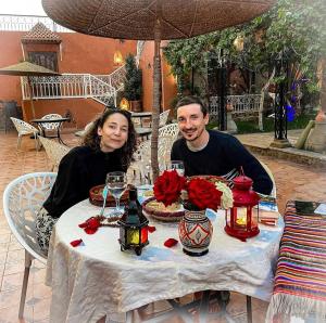 a man and a woman sitting at a table at Riad Chay & Boutique in Ouarzazate