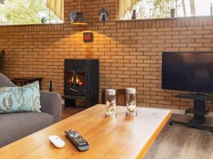 a living room with a television and a fireplace at 6 person holiday home in Væggerløse-By Traum in Marielyst