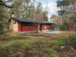 a small house in the middle of a yard at 6 person holiday home in Væggerløse-By Traum in Marielyst