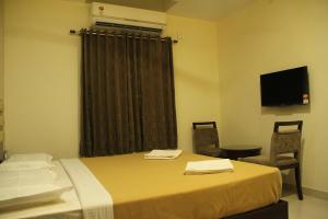 TV a/nebo společenská místnost v ubytování Hotel M.P Temples Inn