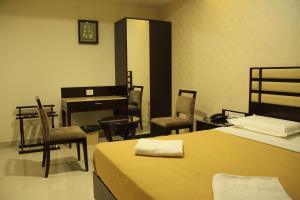 Postel nebo postele na pokoji v ubytování Hotel M.P Temples Inn