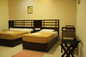 Postel nebo postele na pokoji v ubytování Hotel M.P Temples Inn