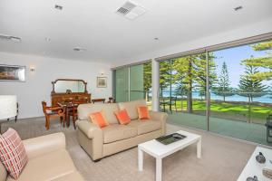 a living room with a couch and a piano at SEABREEZE at Victor Harbor in Victor Harbor