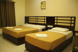 Postel nebo postele na pokoji v ubytování Hotel M.P Temples Inn