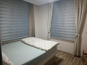 a bedroom with blue blinds on the windows at Happy Accomation Houses 192mt to Harbour no6 in Marmaris