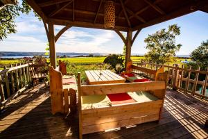 a wooden deck with a gazebo with a table at Bed and Breakfast Panorama in Saint-Laurent-de-l'ile d'Orleans