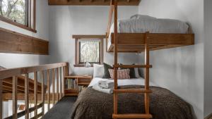 a bedroom with two bunk beds and a staircase at Blairs in Dinner Plain +5 photos
