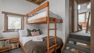 a bedroom with a bunk bed and a staircase at Blairs in Dinner Plain