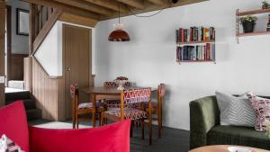 a living room with a table and chairs at Blairs in Dinner Plain