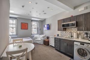 a kitchen and living room with a bed and a table at Cozy Studio Loft Old City Quaint cobblestone St in Philadelphia
