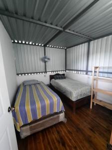 Santa ElenaにあるHotel Colibrí Peténのテント内のベッドルーム1室(ベッド2台付)