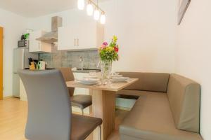 a kitchen and dining room with a table and a couch at Wohnung-C-305 in Böhl