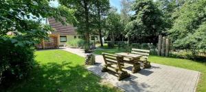 a picnic table and bench in a garden at Wohnung-C-305 in Böhl