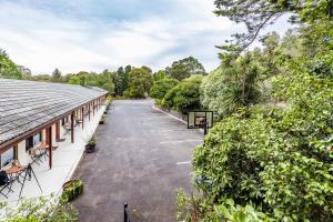 un aparcamiento vacío junto a un edificio en Black Forest Motel, en Macedon