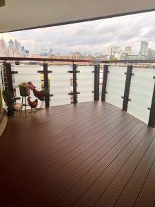 a deck with a view of the water and a bridge at Riverside Private Room TowerBridge in London