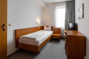 Postel nebo postele na pokoji v ubytování Hotel Fröhlich-Höche
