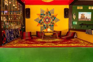 a room with a green and yellow wall with a table at Wild Hippie Chang 