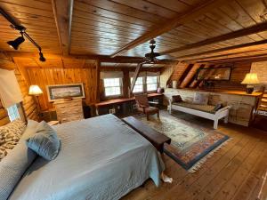 a bedroom with a large bed in a cabin at Doe Creek Horse Ranch in Bandera